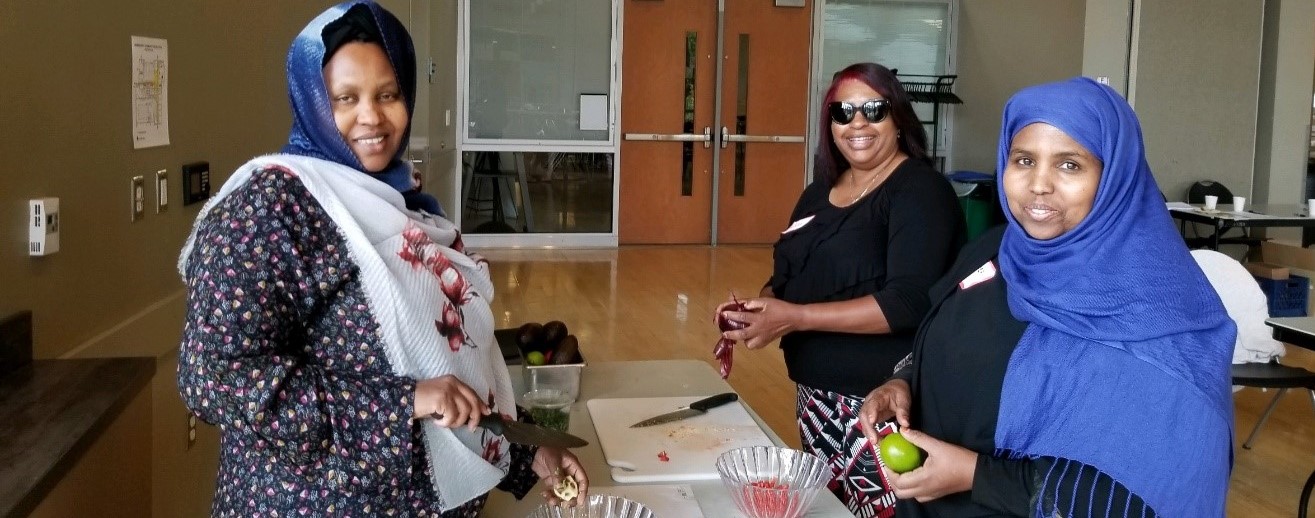 Women cutting fruits and vegetables as part of a CCNP nutrition class