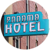 Neon sign with turquoise background reads PANAMA HOTEL
