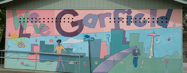A colorful mural on the side of a building that says We Love Garfield