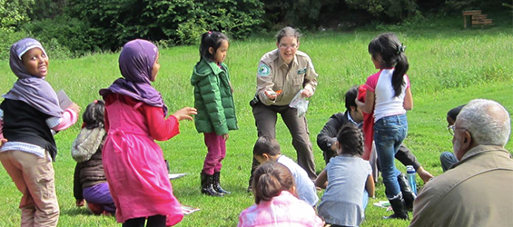 Volunteer teaching children at a park