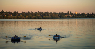Green Lake Park at sunset, with three rowboats 