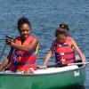 Two girls paddling a canoe
