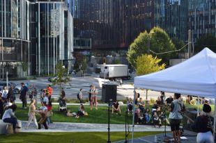 A crowd listening to a public concert on lawn in South Lake Union in Seattle