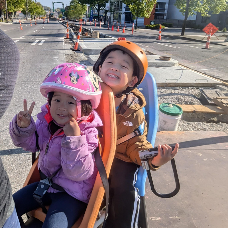 Children on the back of the bike smiling with peace signs Children on the back of the bike smiling with peace signs