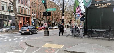 A reverse curb ramp in Pioneer Square at the intersection of 1st and S Washington Street