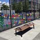 A pickleball court built in a street with artwork and a bench