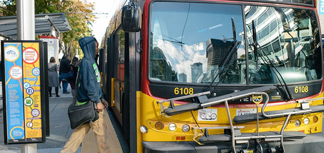 A man waits to board a Metro bus