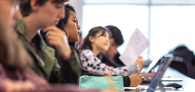 Row of college students sitting in class