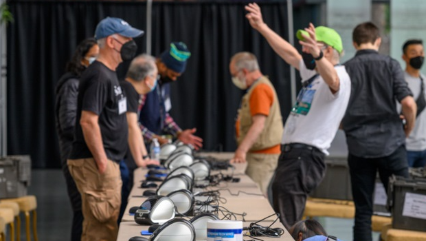 Technologists setting up equipment at a health clinic