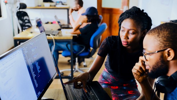 Two people working on a project looking at a screen