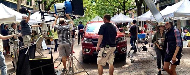 A film crew sets up around a car for a commercial in Seattle