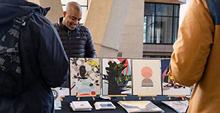A public table displays artwork