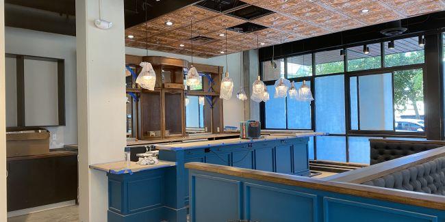 The same space with a new bar and kitchen under construction