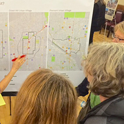 2 people writing on maps 