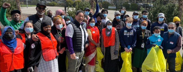 Mayor Harrell standing with group of volunteers at community cleanup