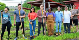 Smiling group of diverse people standing in a garden