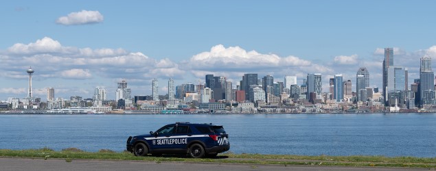 Seattle Police Department vehicle with city skyline in background