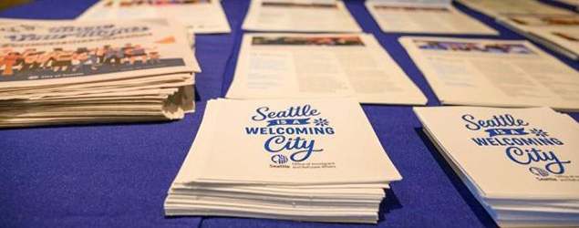 A table with welcome to the city of seattle handouts as well as a newsletter