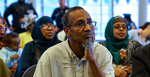 People sitting and watching an event take place